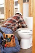 Contractor installing a toilet